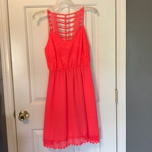 Pink/coral summer dress with lace detail.